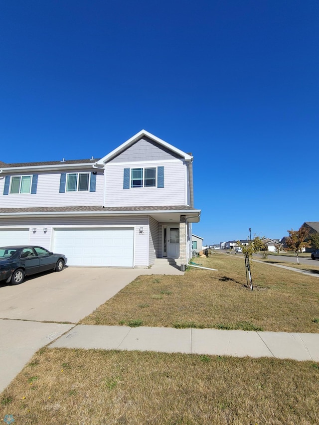 view of front of property featuring a garage and a front lawn