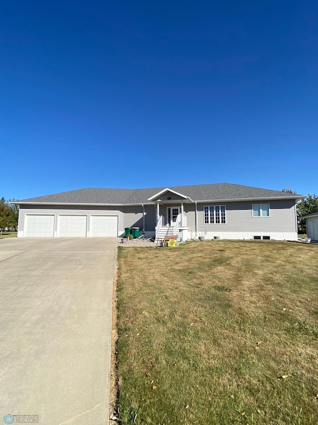 single story home featuring a front yard and a garage