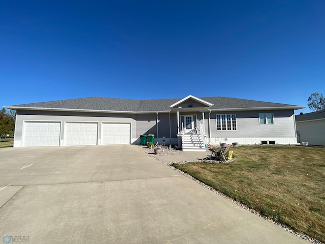 ranch-style home featuring a garage and a front yard