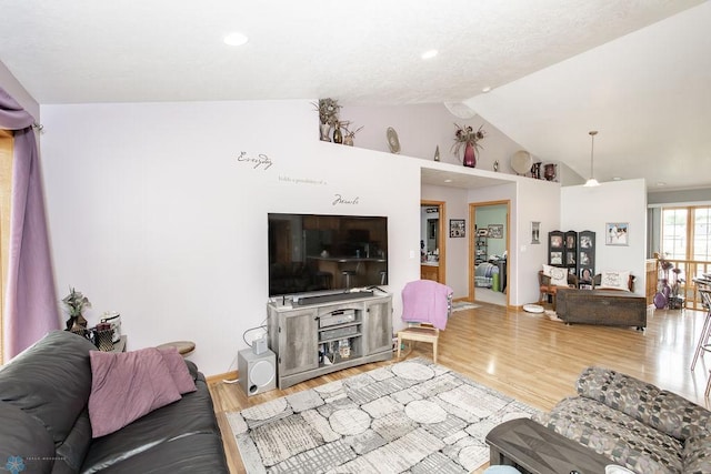 living room featuring high vaulted ceiling and hardwood / wood-style flooring