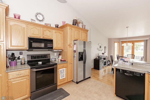 kitchen featuring light brown cabinets, lofted ceiling, decorative light fixtures, black appliances, and light carpet