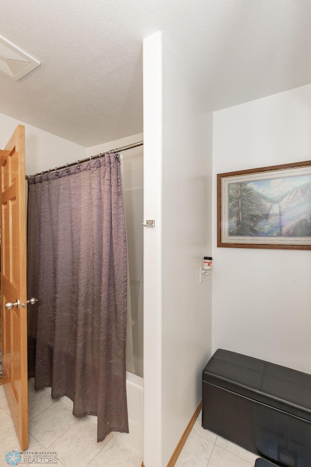 bathroom featuring shower / tub combo and tile patterned floors