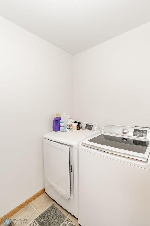 laundry room featuring light tile patterned flooring and washer and dryer