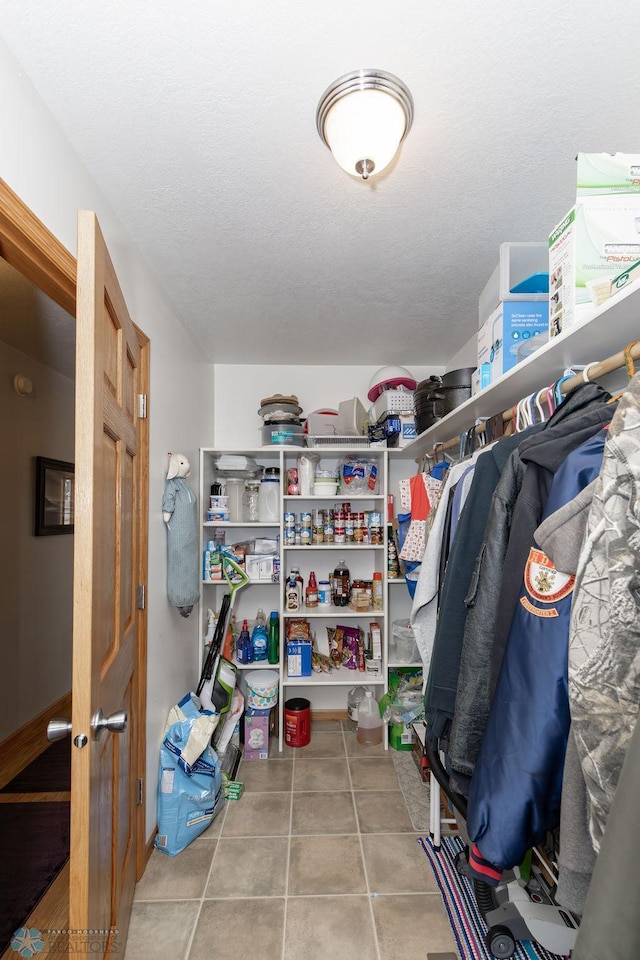 spacious closet with tile patterned flooring