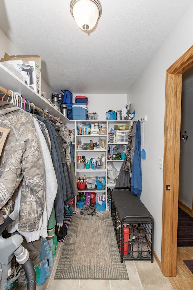 walk in closet with light tile patterned flooring