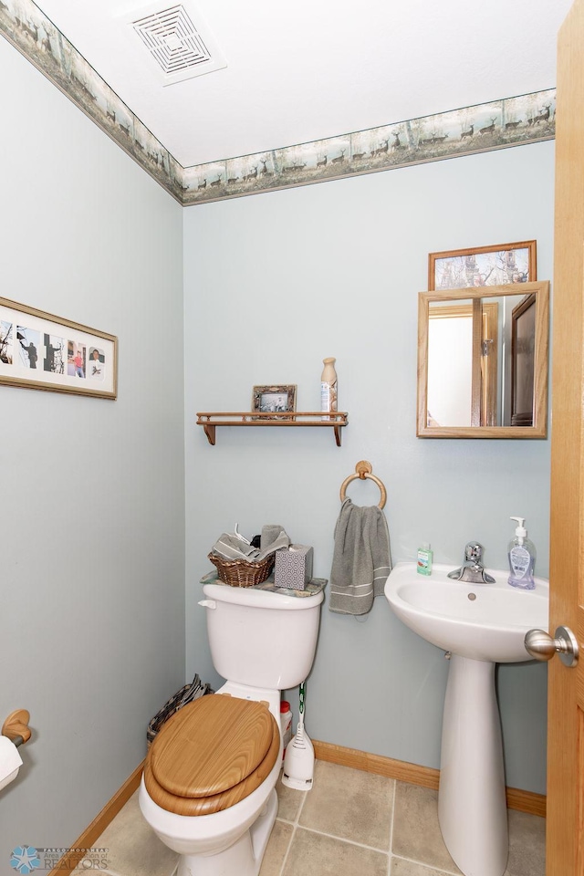 bathroom featuring tile patterned flooring and toilet