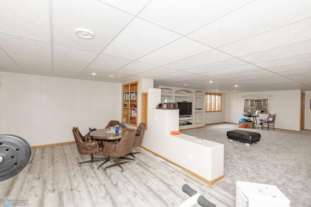 dining room featuring a paneled ceiling and light hardwood / wood-style floors