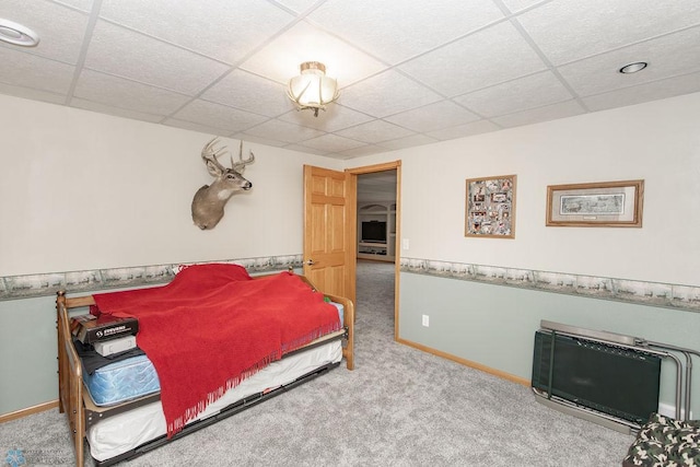 bedroom featuring carpet floors and a paneled ceiling