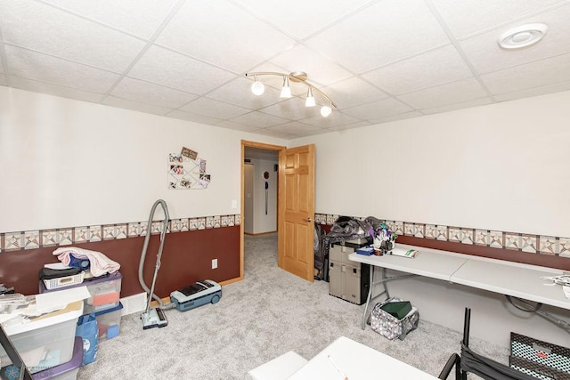 carpeted office featuring a drop ceiling