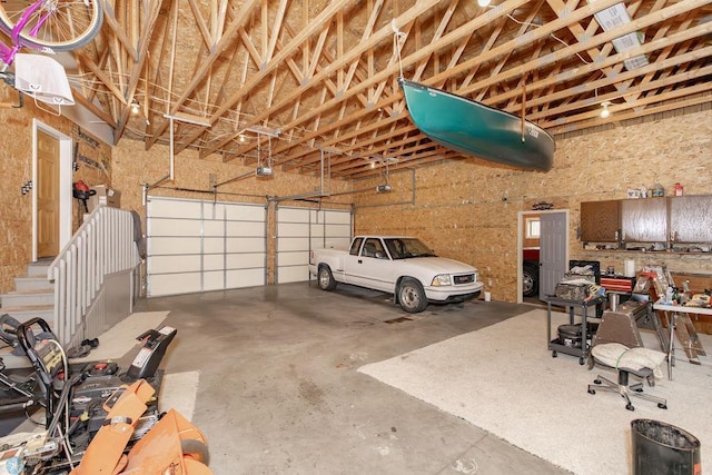 garage with a garage door opener and a carport