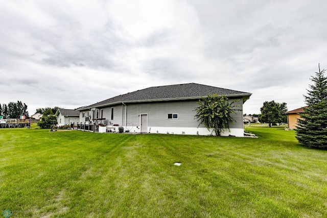 back of house with a lawn