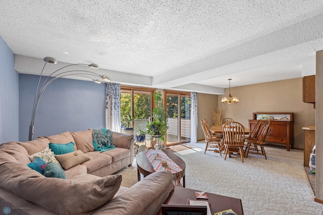 living room featuring light carpet, a chandelier, and a textured ceiling