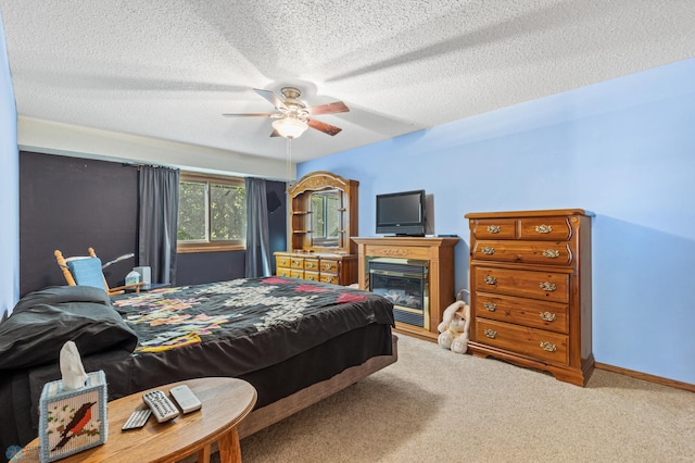 bedroom with a textured ceiling, ceiling fan, and carpet floors