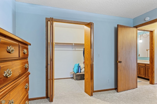 carpeted bedroom with a textured ceiling and a closet