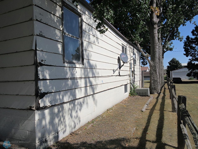 view of side of home with central air condition unit