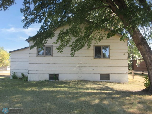 view of property exterior with a lawn