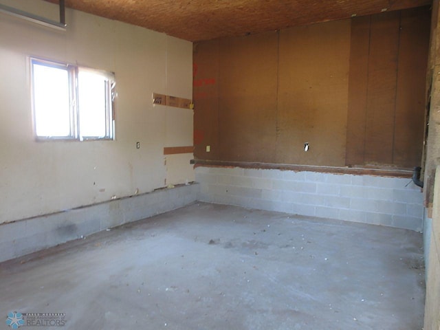 unfurnished room with concrete flooring