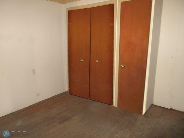 unfurnished bedroom with dark hardwood / wood-style floors