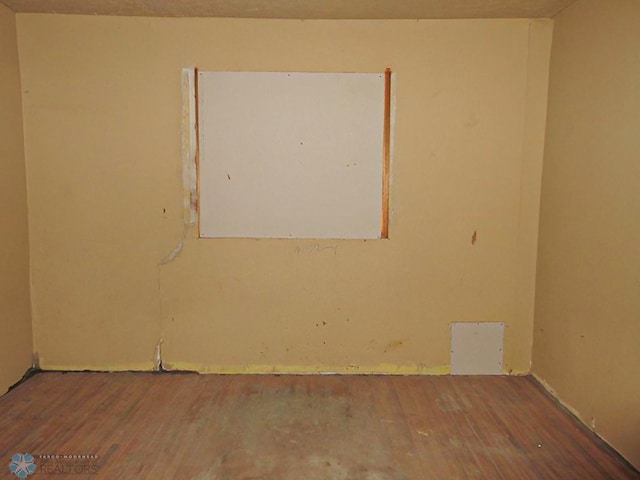 unfurnished room featuring hardwood / wood-style flooring