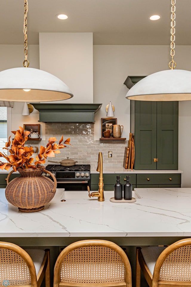 kitchen with pendant lighting, decorative backsplash, black range with gas cooktop, light stone countertops, and premium range hood