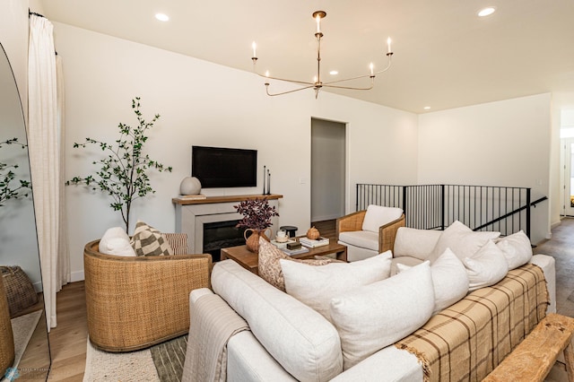 living room with light hardwood / wood-style floors and an inviting chandelier