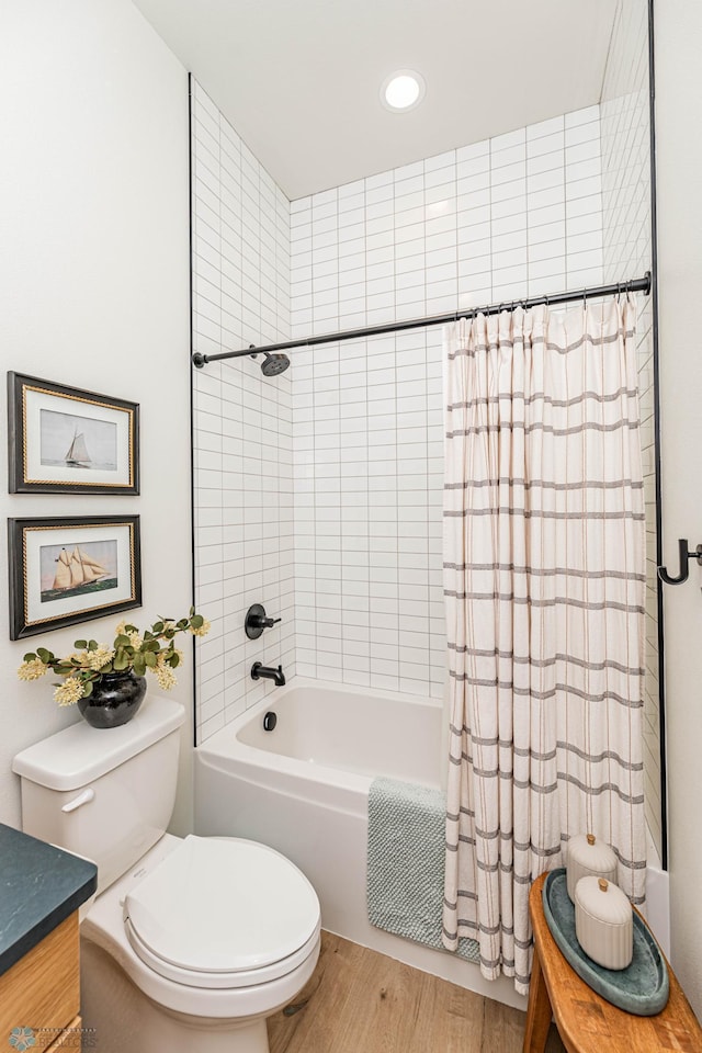 full bathroom with shower / tub combo, vanity, toilet, and hardwood / wood-style flooring