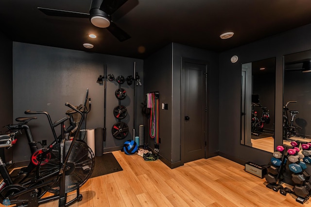 exercise area with light wood-type flooring and ceiling fan