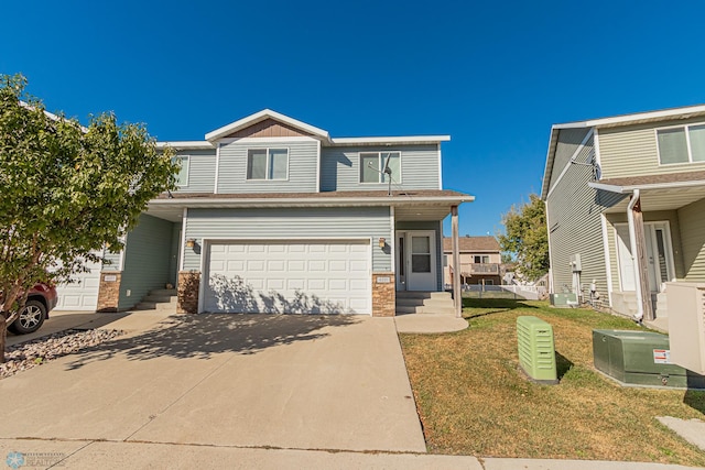 view of front of property with a front yard and a garage