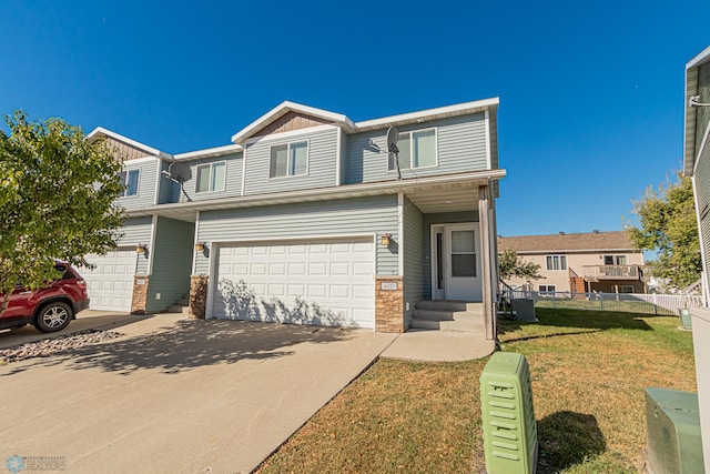 view of property with a front lawn and a garage