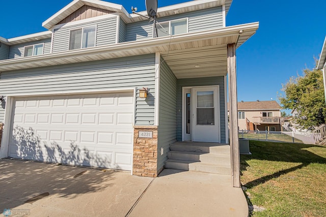 view of front of house with a front yard and a garage