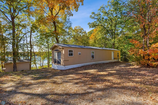 view of side of home featuring a storage unit