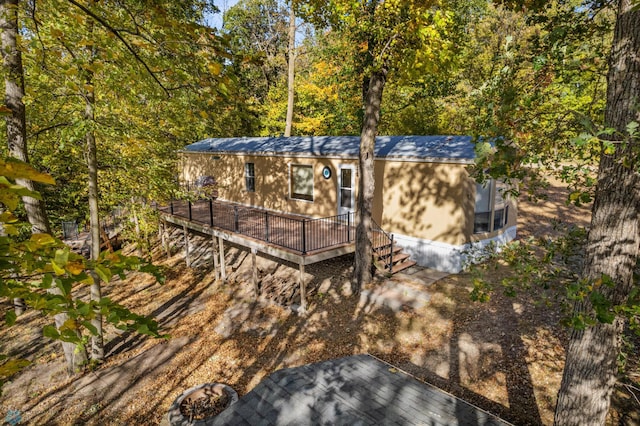 rear view of property with a wooden deck