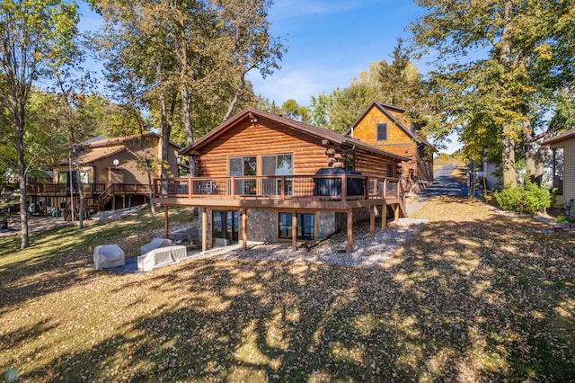 back of house with a yard and a wooden deck