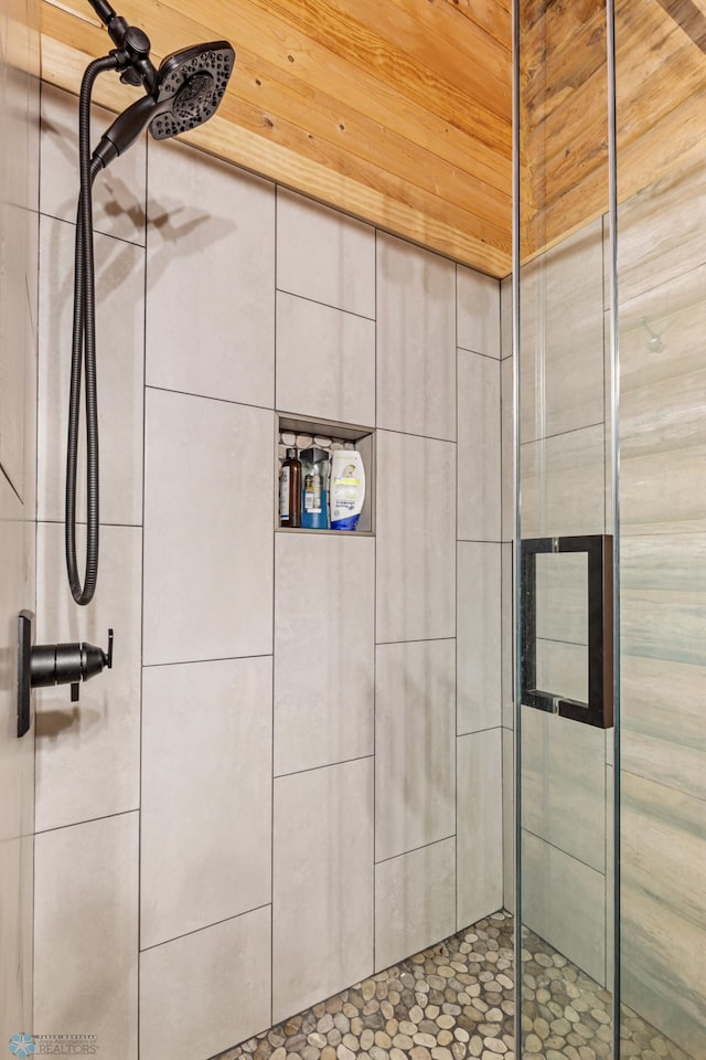 bathroom with a shower with door