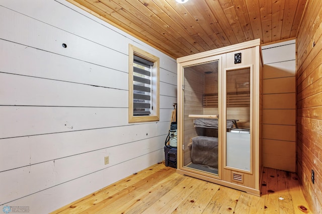 view of sauna with wood-type flooring, wood ceiling, and wood walls