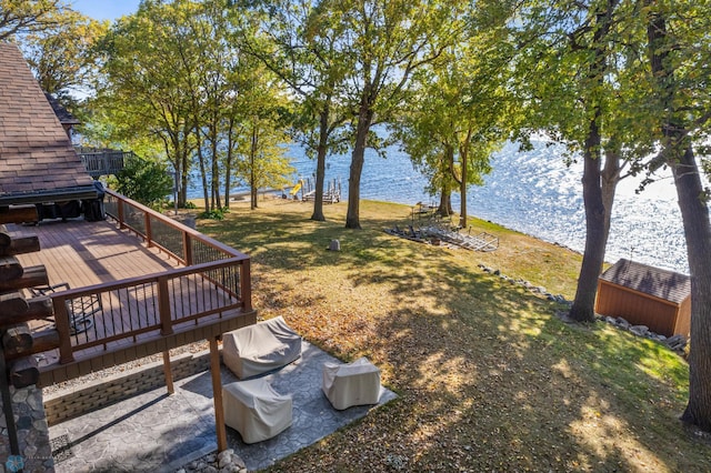 view of yard with a deck with water view