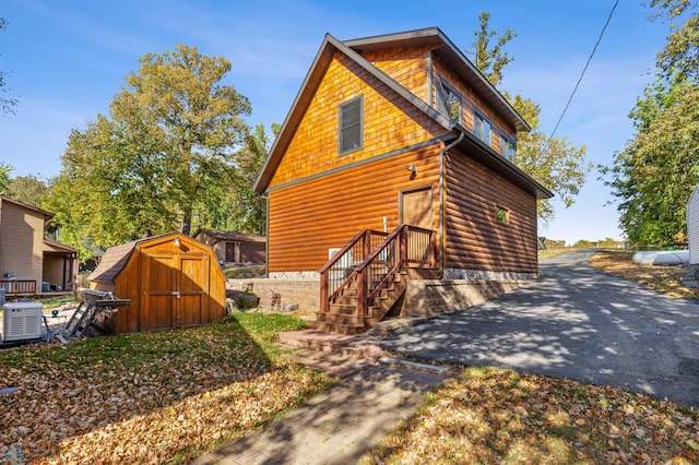 view of side of home with a storage unit