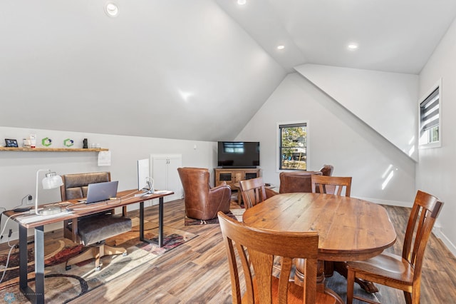 dining area featuring lofted ceiling and light hardwood / wood-style floors