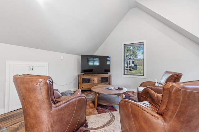 living room featuring wood-type flooring and vaulted ceiling