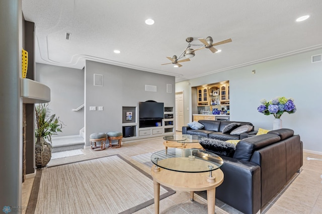 living room featuring a textured ceiling, light tile patterned floors, and ceiling fan