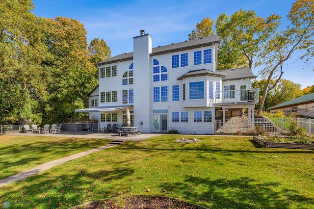 back of property with a patio and a yard