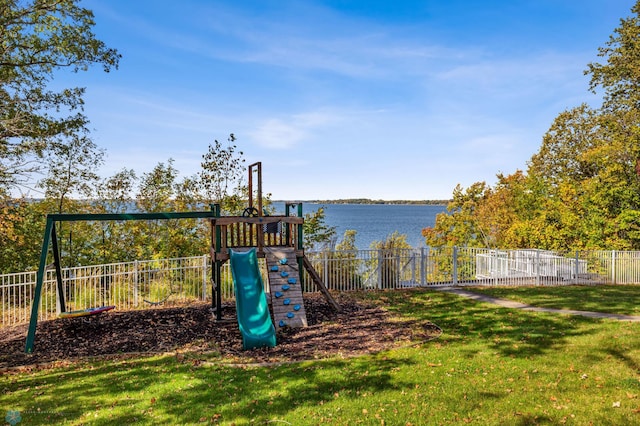 view of play area with a water view and a lawn