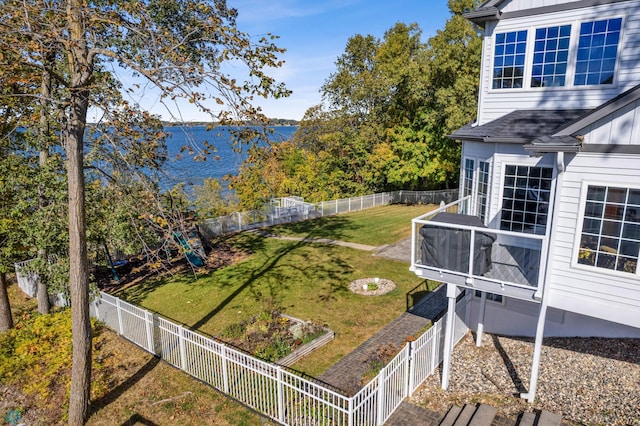 view of yard with a water view and a sunroom