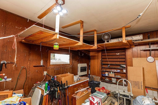 basement with ceiling fan and heating unit