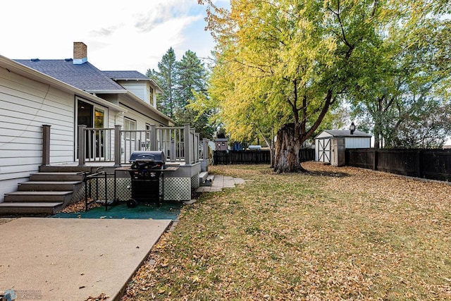 view of yard featuring a storage unit and a patio