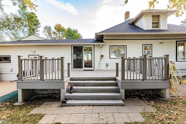 rear view of house with a wooden deck