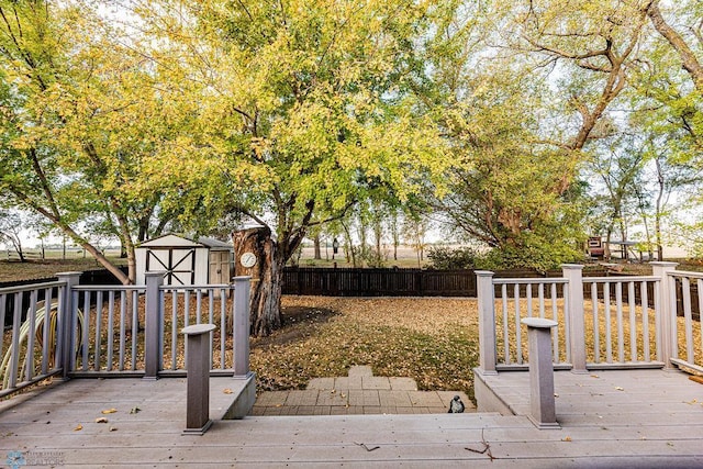 wooden terrace featuring a storage unit