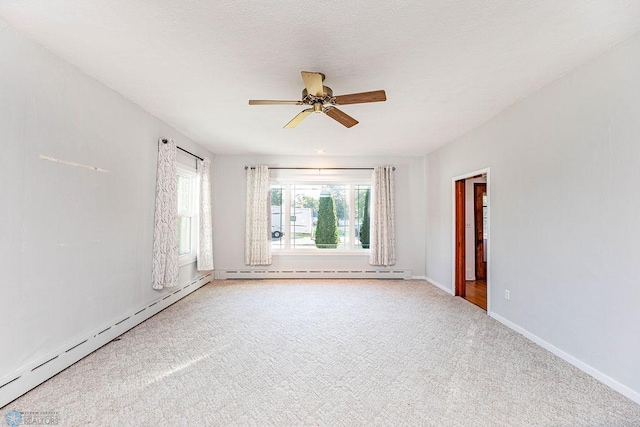 spare room featuring carpet floors, baseboard heating, and ceiling fan