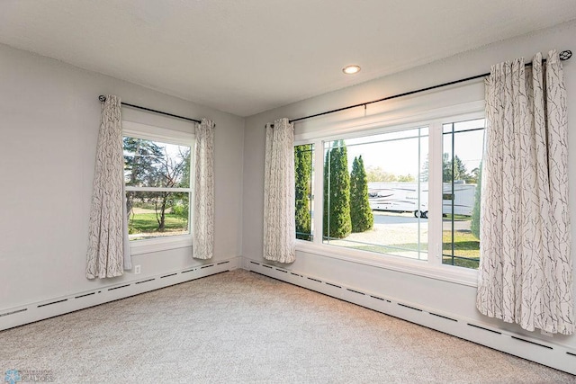 empty room featuring a baseboard radiator and carpet flooring