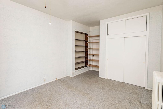 unfurnished bedroom with a closet and carpet flooring